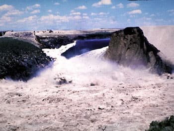 Teton Dam failing on June 5, 1976, with water bursting through the right abutment.