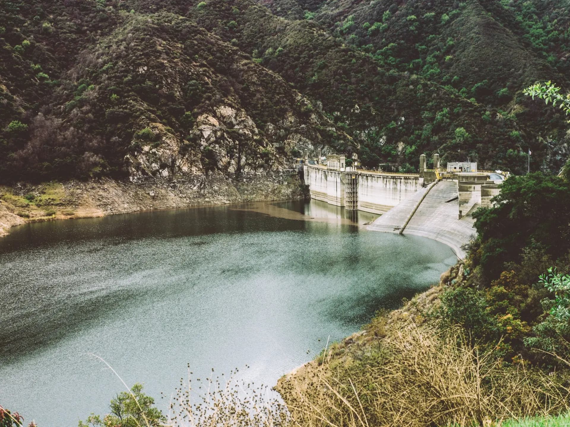 Concrete dam and reservoir in a steep canyon