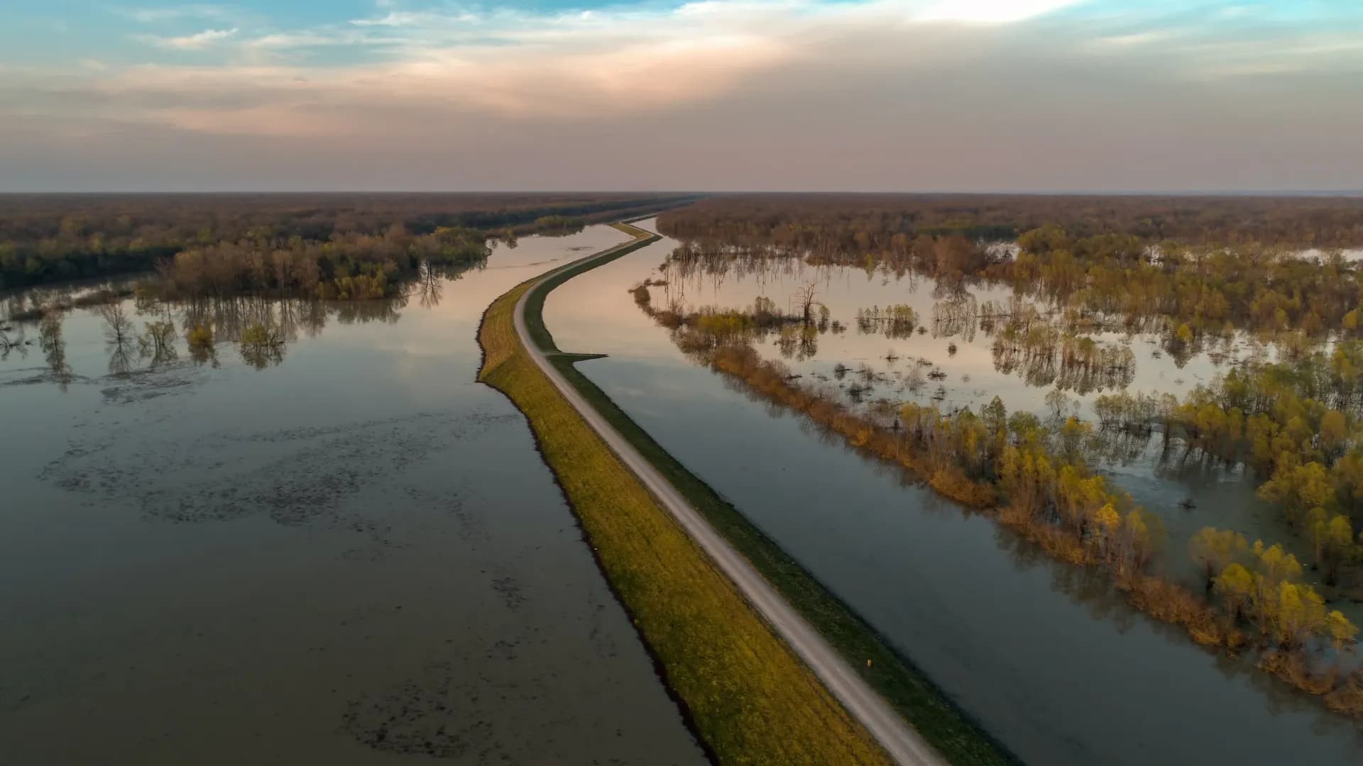 Aerial view of a levee crest between flooded fields