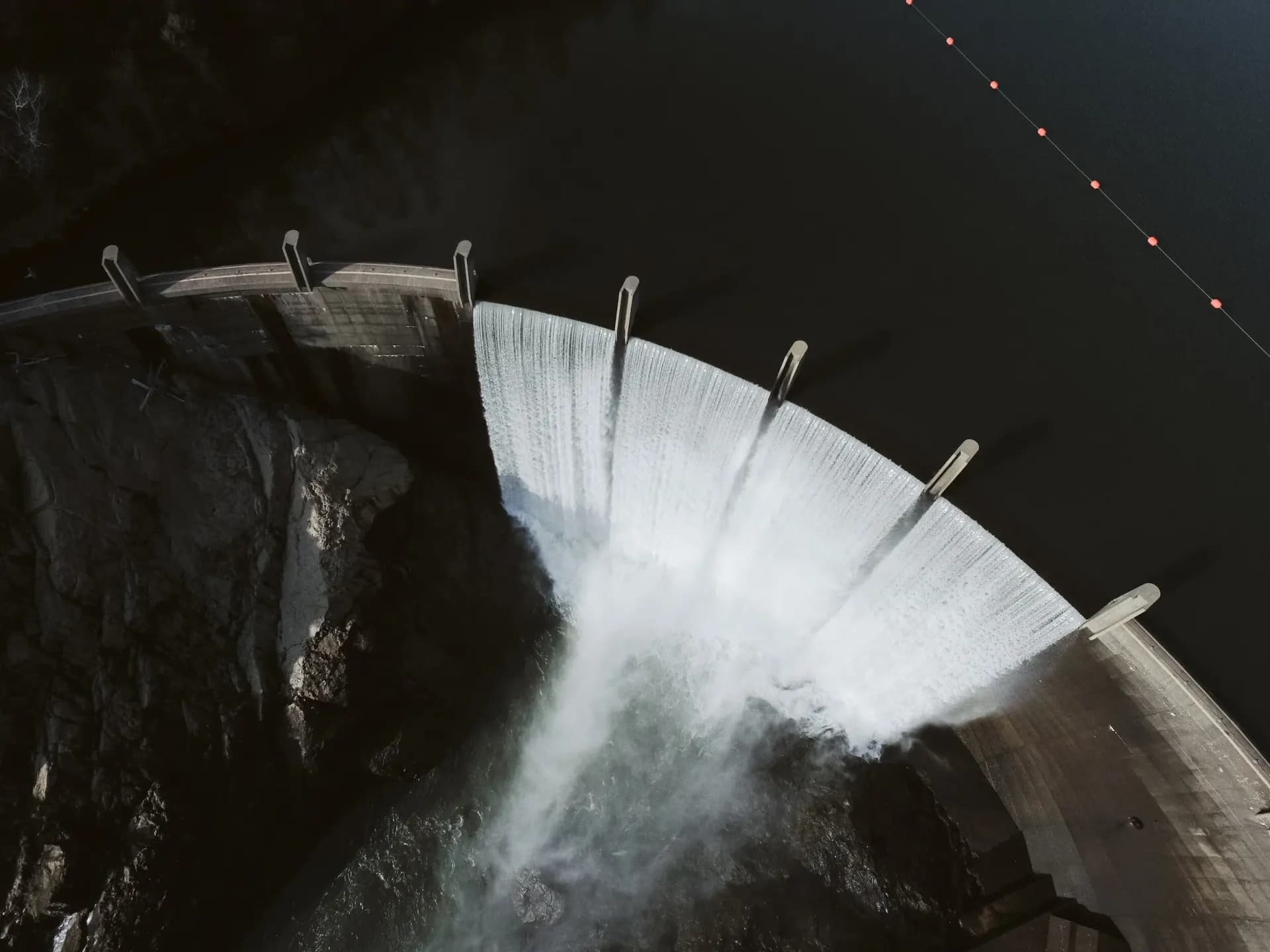 Water spilling over a concrete arch dam