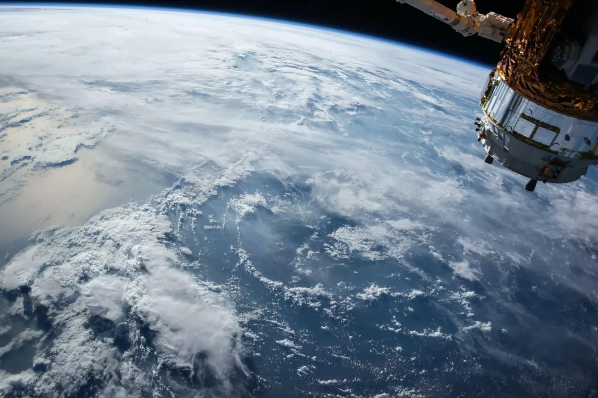 Earth seen from orbit with a spacecraft in frame