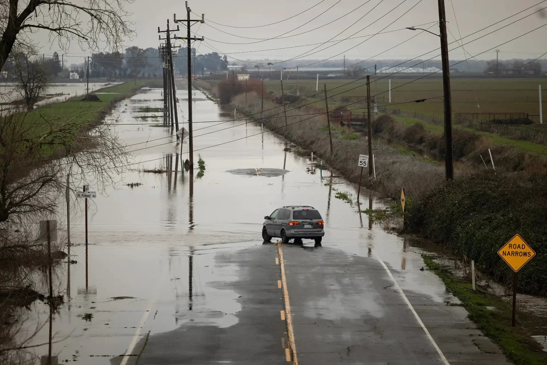 Flooded road beside a levee during high water