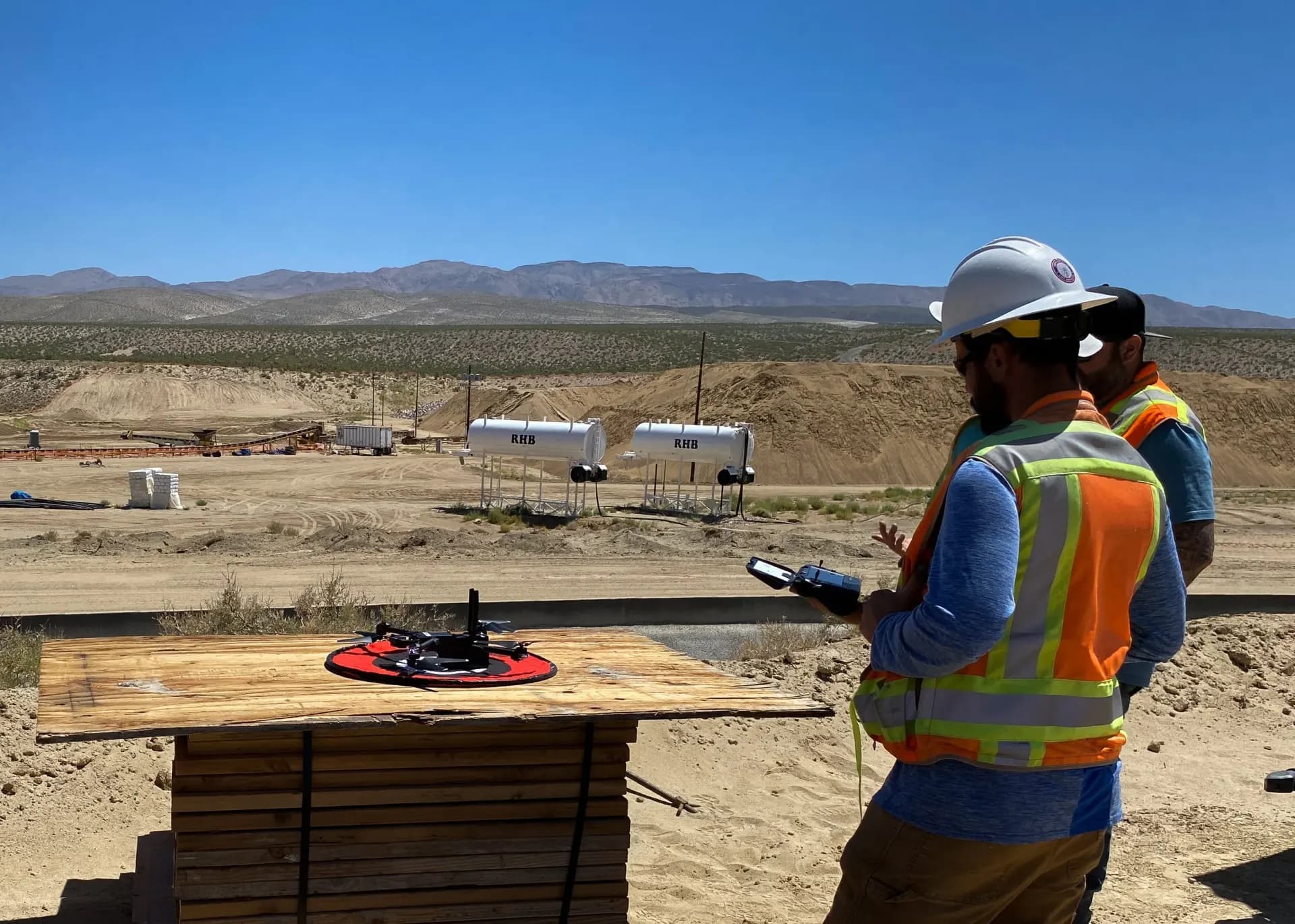Field crew preparing a survey drone on a construction site